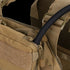 Close-up of the Condor Tidepool Hydration Carrier in tan, featuring a black hydration tube from a zippered pocket and adjustable shoulder straps—perfect for military use or the shooting range.