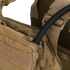 Close-up of the Condor Tidepool Hydration Carrier in tan, featuring a black hydration tube from a zippered pocket and adjustable shoulder straps—perfect for military use or the shooting range.