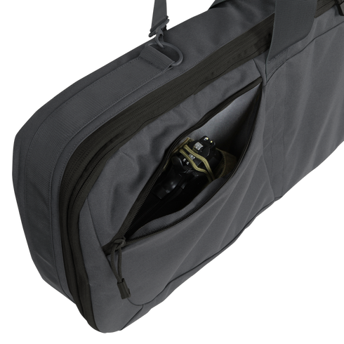 A close-up of the Condor 36" Javelin Rifle Case in gray, featuring a partially open exterior zippered pocket with black headphones visible inside.