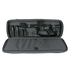 A black rifle with scope and magazines is stored in the Condor 36" Javelin Rifle Case, a padded gray carrying case with accessory compartments.
