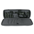 A black rifle with scope and magazines is stored in the Condor 36" Javelin Rifle Case, a padded gray carrying case with accessory compartments.