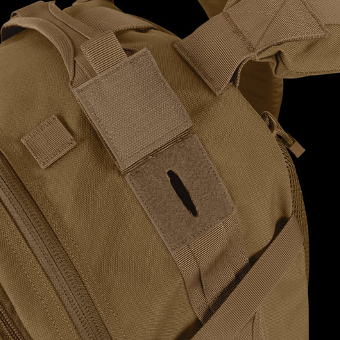 Close-up of the Condor Orion Assault Backpack 50L in brown, built for EDC with a velcro patch and hydration tube opening.