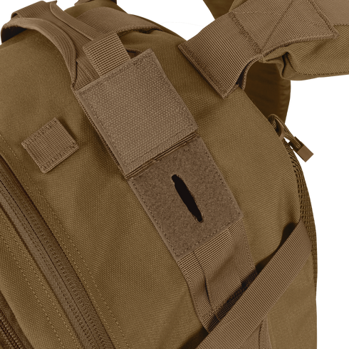 Close-up of the Condor Orion Assault Backpack 50L in brown, built for EDC with a velcro patch and hydration tube opening.