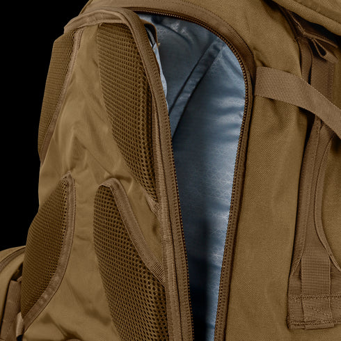 Close-up of the Condor Orion Assault Backpack 50L in brown, showing a partially opened zipper that reveals the blue interior lining.