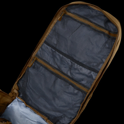 The Condor Orion Assault Backpack 50L is shown open on a flat surface, revealing several zippered mesh compartments inside the lid.