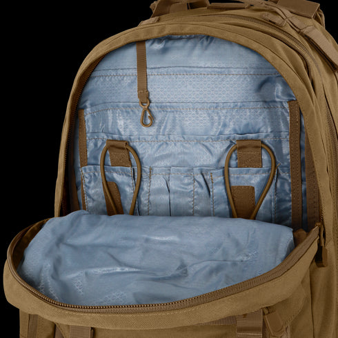 The Condor Orion Assault Backpack 50L in brown showcases organized interior pockets, loops, and compartments for EDC or range gear, displayed against a neutral background.