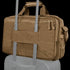 The Condor Elite Metropolis Briefcase in tan, featuring two zippers and a rear strap, is secured to the handle of a rolling suitcase.