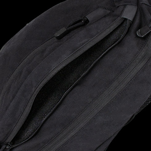 Close-up of a partially unzipped Condor Elite Sector Sling Bag 18L by Condor, highlighting the zipper and pull tabs.