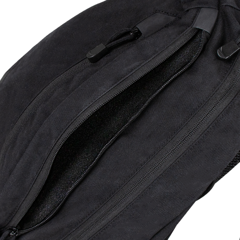Close-up of a partially unzipped Condor Elite Sector Sling Bag 18L by Condor, highlighting the zipper and pull tabs.