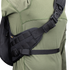 A close-up of a person wearing the Condor Elite Sector Sling Bag 18L by Condor, featuring black tactical straps with clips and padding, over an olive green long-sleeve shirt.