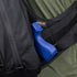 A blue training gun is partially visible in a black Condor Elite Sector Sling Bag 18L by Condor, worn by a person in a green shirt; a CORDURA fabric label appears inside the bag.