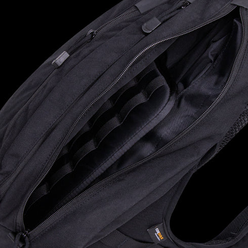 A close-up view of the open Condor Elite Sector Sling Bag 18L by Condor, highlighting its interior compartments and zipper details.