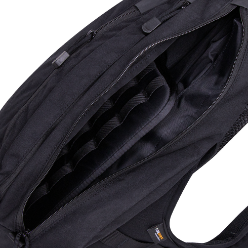 A close-up view of the open Condor Elite Sector Sling Bag 18L by Condor, highlighting its interior compartments and zipper details.