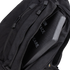 A Condor Elite Sector Sling Bag 18L in black is shown with a partially open zipper, revealing a protective ballistic plate inside.
