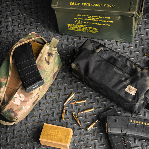 Condor Kit Bag - MultiCam Black, loaded magazines, bullet rounds, and an ammo box on textured metal—essential gear for Military or Law Enforcement ops.