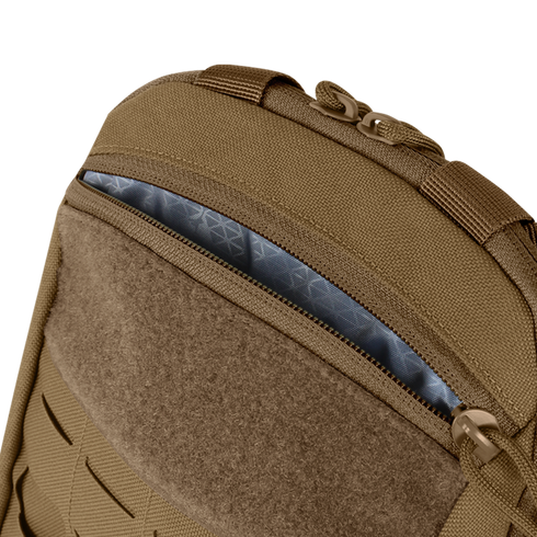 Close-up of the Condor LCS Tidepool Hydration Carrier, a tan backpack with military-inspired design, partially unzipped to reveal its patterned gray interior lining and rugged fabric construction.