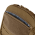 Close-up of the Condor LCS Tidepool Hydration Carrier, a tan backpack with military-inspired design, partially unzipped to reveal its patterned gray interior lining and rugged fabric construction.