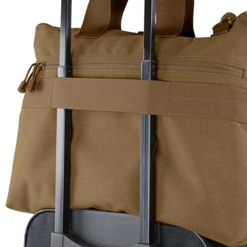 A Condor Aviator Bag 15L in brown is secured on top of a rolling suitcase using the suitcase handle.