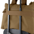 A Condor Aviator Bag 15L in brown is secured on top of a rolling suitcase using the suitcase handle.