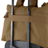A Condor Aviator Bag 15L in brown is secured on top of a rolling suitcase using the suitcase handle.