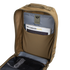 Open tan Prime Pack 21L by Condor showing inner pocket with booklets labeled Condor Elite and Condor, plus a mesh zippered compartment below.