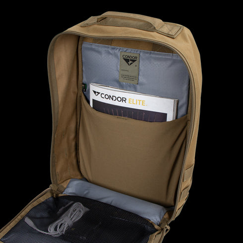 Open tan Condor Prime Pack 21L backpack with a gray interior, featuring a pocket holding a Condor brochure and a gray mesh compartment on the inside flap—perfect for organizing Military or First Responder gear.
