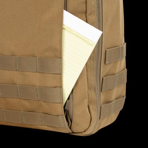 Close-up of the Condor Prime Pack 21Ls tan pocket with a yellow legal pad partially visible inside.