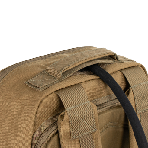 A close-up of the Condor Prime Pack 21L tan canvas bag highlights its handle, zipper, and strap attachment on a plain white background.