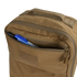 The Condor Prime Pack 21L, in tan, has a front zippered pocket partially open, revealing a black pen, blue pen, and a marker inside.
