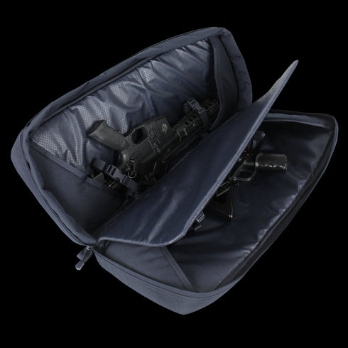 A partially unzipped black Condor 27 Dispatch Take Down Case reveals a compact EDC firearm securely stored inside.