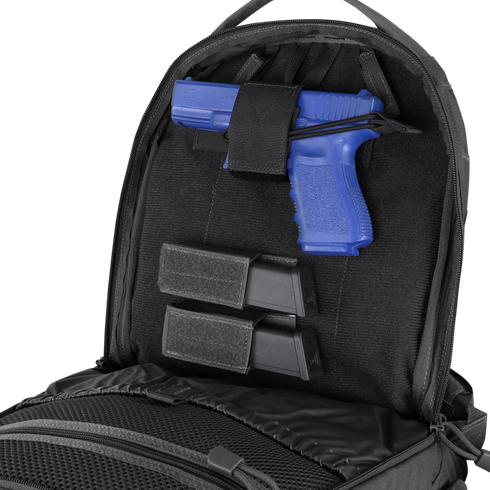 A blue training pistol and two black magazines are secured inside the back compartment of a Condor Elite Fail Safe Urban Backpack Gen II 18L by Condor.