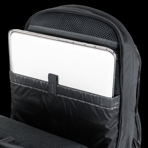 A silver laptop partially inserted into a padded compartment inside a Condor Elite Fail Safe Urban Backpack Gen II 18L by Condor, designed for first responder essentials.