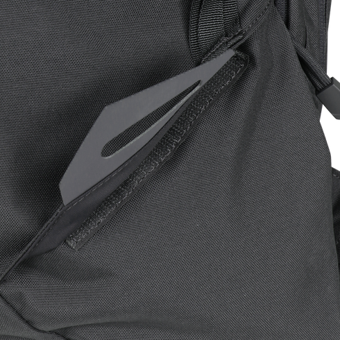 Close-up of the Condor Elite Fail Safe Urban Backpack Gen II 18L by Condor in black, featuring a partially open zipper pocket that reveals a flat, gray metal tool—perfect for bushcraft or first responder use.