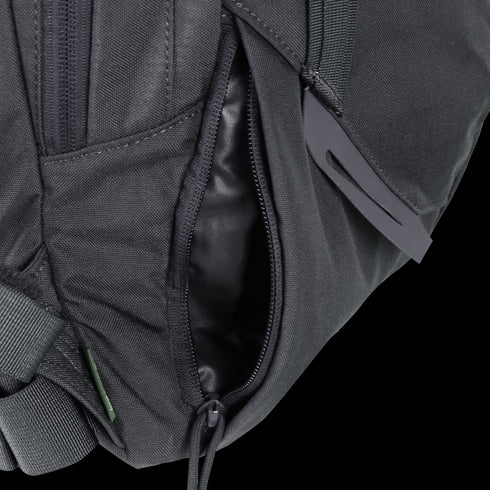 Close-up of the Condor Elite Fail Safe Urban Backpack Gen II 18L by Condor, featuring a black finish, partially open zippered pocket revealing fabric lining inside, and a plastic buckle on the strap.