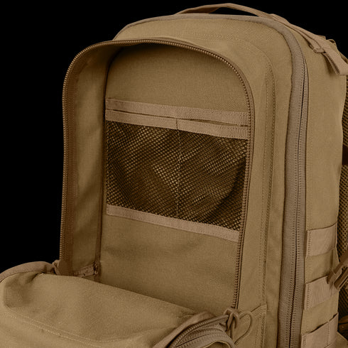 Close-up of the Condor Compact Assault Backpack Gen II 24L in tan, ideal for bushcraft or the range, featuring an open inner compartment with a mesh pocket and zipper.