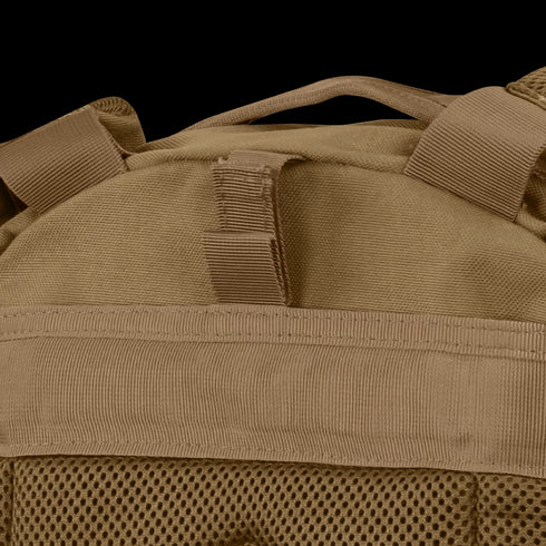 Close-up of the Condor Compact Assault Backpack Gen II 24L in tan, a top pick among military and bushcraft users, highlighting its webbing, mesh fabric, and sturdy top carrying handle.