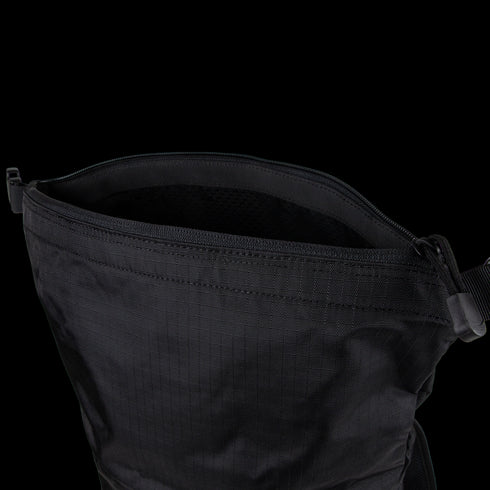 A close-up of the Condor Aero Roll-Top Backpack 25L | SALE, open to reveal its plain interior and visible strap, shown in black.