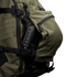 Close-up of the Condor Nomad Backpack 25L in green, showing its zippered side pocket partially open with the handle of a black tool or equipment visible inside.
