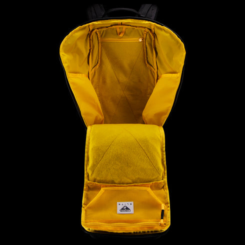The Condor Nomad Backpack 25L in yellow is shown open, displaying interior compartments, a zippered pocket, and a fabric logo patch—perfect for everyday carry or first responder gear.