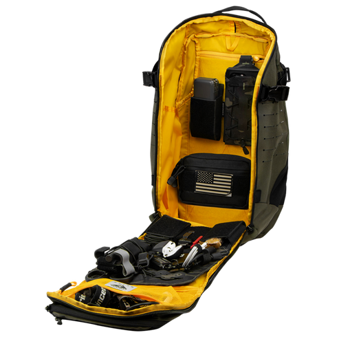 The Condor Nomad Backpack 25L is shown fully unzipped, its yellow interior revealing organized compartments with tools, gear, pouches, and an American flag patch.