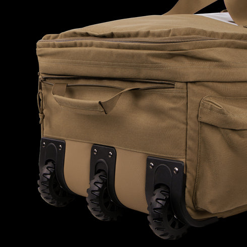 A close-up of the Condor Haul 37 Rolling Duffle in khaki, featuring three black wheels and several zippered compartments.