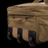 A close-up of the Condor Haul 37 Rolling Duffle in khaki, featuring three black wheels and several zippered compartments.