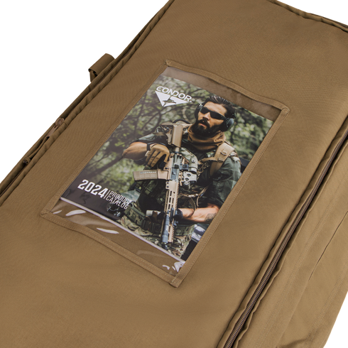A tan Condor Haul 37 Rolling Duffle with a clear pocket holds a 2024 Condor catalog showing a man in military gear holding a rifle.