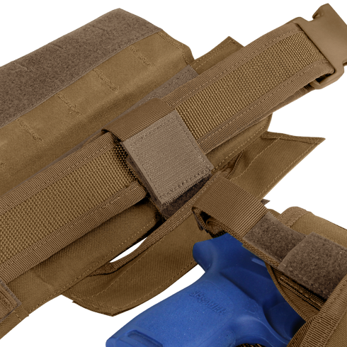 Close-up of the Condor Slim Battle Belt in brown nylon, securely holding a blue plastic training handgun—perfect for military training or first responder drills.