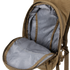 The Hydration Backpack 8L by Condor is open, displaying its brown exterior and grey patterned interior, revealing the main compartment and part of the zipper.