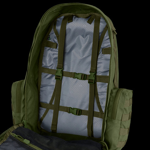 The Condor 3-Day Assault Backpack 50L is open, displaying interior straps and buckles for securing items, a light gray lining, and a mesh pocket visible on the left side.