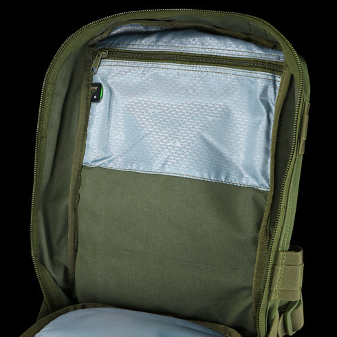 The Condor Compact Assault Backpack 24L opens to reveal a spacious main compartment with an inner zippered mesh pocket and light blue lining—perfect for organizing military or first responder gear.