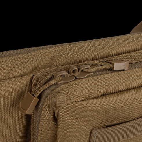 Close-up view of the Condor 36 Single Rifle Case in brown, featuring two front-compartment zippers with pull cords—perfect for everyday carry or bushcraft essentials.