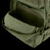 A close-up of an open front pocket on the Condor Medium Assault Backpack 30L in olive green, showing its interior compartment.