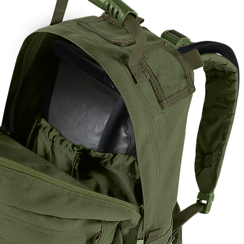 A close-up of the Condor Medium Assault Backpack 30L in olive green shows its top compartment unzipped, revealing an internal hydration bladder.